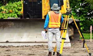 Professional surveyor using a total station, illustrating why finding property lines requires accurate field measurements