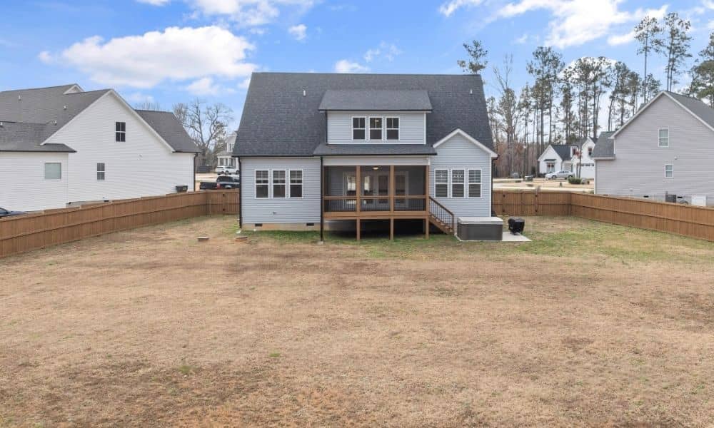 Suburban home with a fenced backyard, showing the property area where property line markers guide fence replacement